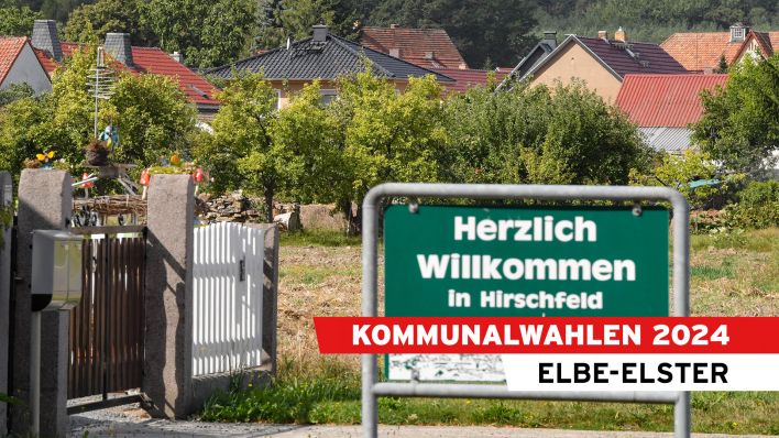 Ein Schild vor einer Wohnsiedlung mit der AUfschrift "Herzlich Willkommen in Hirschfeld"