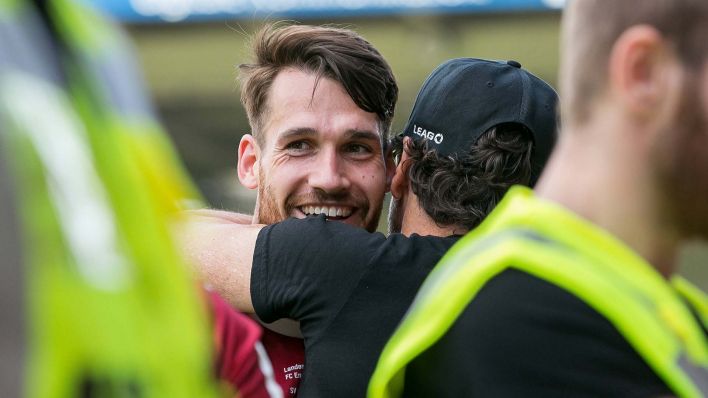 Jonas Hildebrandt (li.) umarmt den Cheftrainer des FC Energie Cottbus, Claus-Dieter "Pele" Wollitz [Quelle: IMAGO / Fotostand]