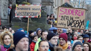 PRODUKTION - 19.12.2024, Berlin: Transparente mit der Aufschrift "Demokratie braucht Wissenschaft" und "Studieren in Berlin wird richtig unsexy" werden bei einer Demonstration der Berliner Wissenschaft unter dem Motto #SaveBrainCity! vor dem Abgeordnetenhaus gezeigt. D